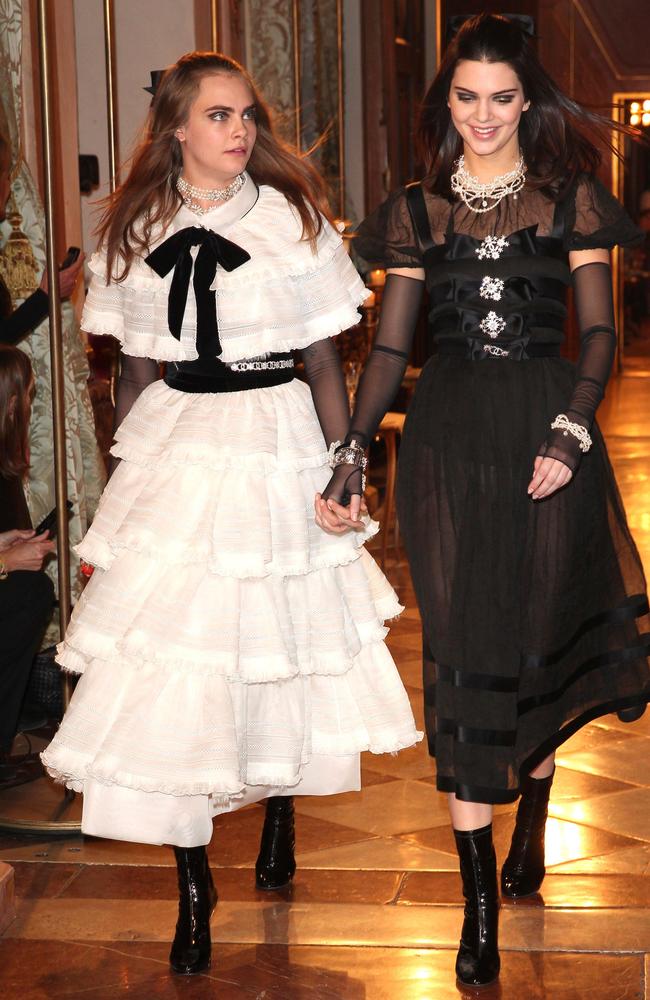 Fashionable BFFs ... Cara Delevingne and Kendall Jenner covered up for Chanel’s Metiers d'Art Collection show in Austria. Picture: Getty Images