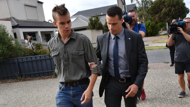 Protester Tadhg Porter is led away from Premier Jay Weatherill. Picture: David Mariuz/AAP