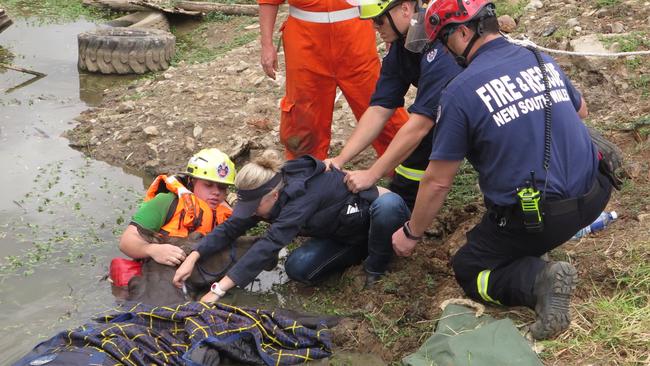 Vet Dr Kylie Hardwicke and emergency crews rescuing Matilda who was trapped in a dam in Marsden Park. Picture: Fire and Rescue NSW