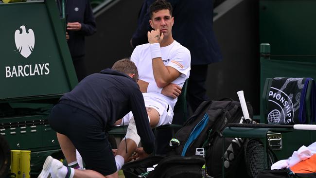 Thanasi Kokkinakis receives medical treatment before retiring injured during his singles second round match against Lucas Pouille. Picture: Mike Hewitt/Getty Images