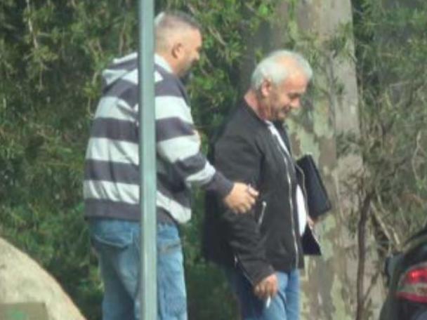 Peter Bollas, George Haritos and a Transclean associate are photographed meeting near Epping train depot on May 6.