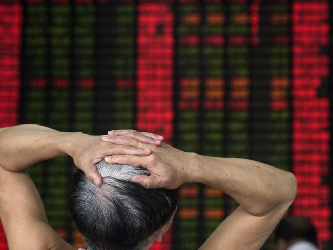 To go with China-economy-stocks-policy,FOCUS by Bill SAVADOVE In this photo taken on September 1, 2015, an investor reacts in front of a digital board showing stock market movements at a brokerage house in Shanghai. Chinese authorities have deployed vast sums to try to stabilise slumping share prices, but have to contend with a rumour-driven market and investors like Wang Youfu, whose latest sure thing is a chemical firm that lost $180 million last year. AFP PHOTO / JOHANNES EISELE