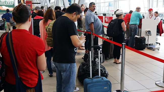 DAILY TELEGRAPH - Flights to the Gold Coast, Ballina and Brisbane have been delayed or cancelled due to the effects of Cyclone Oswald. Stranded passengers in Terminal 2 at Sydney Domestic Airport. Picture: Toby Zerna