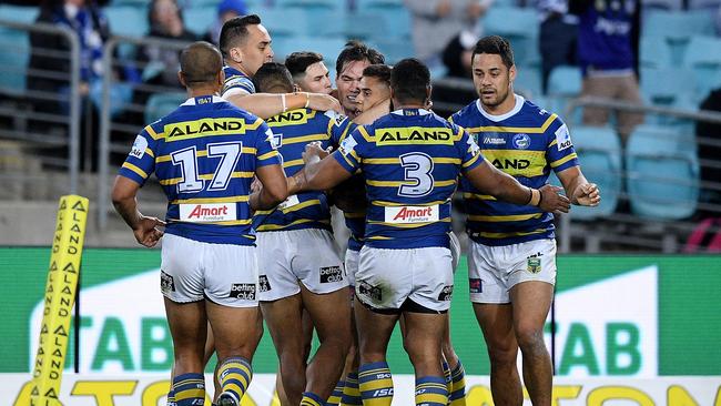 Kaysa Pritchard of the Eels (centre) celebrates with teammates after scoring a try during the Round 19 NRL match between the Parramatta Eels and the Canterbury-Bankstown Bulldogs at ANZ Stadium in Sydney, Thursday, July 19, 2018. (AAP Image/Dan Himbrechts) NO ARCHIVING, EDITORIAL USE ONLY