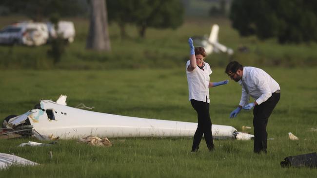 Investigators at the scene of plane wreckage at Kybong. Picture: Lachie Millard