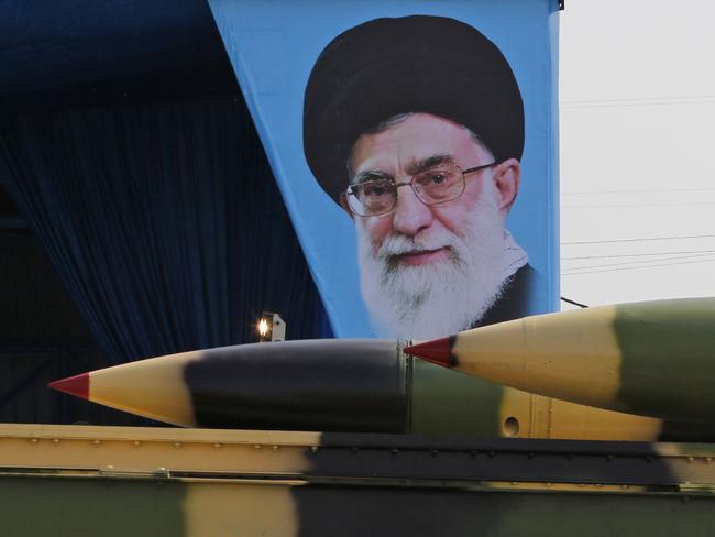 An Iranian military truck carries surface-to-air missiles past a portrait of Iran's Supreme Leader Ayatollah Ali Khamenei during a parade on the occasion of the country's annual army day on April 18, 2018, in Tehran. President Hassan Rouhani said that Iran "does not intend any aggression" against its neighbours but will continue to produce all the weapons it needs for its defence. / AFP PHOTO / ATTA KENARE