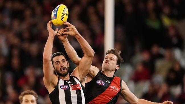 Brodie Grundy flies for a mark against Patrick Ambrose during Collingwood’s win on Friday. Picture: AAP Image/Scott Barbour.