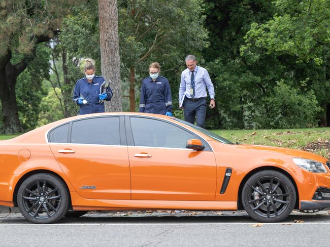 Police are also inspecting public toilets near where the orange Holden Commodore was left. Picture: Tony Gough