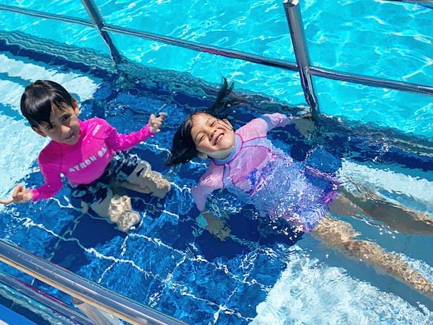 Siblings Santiago and Yindi Cooper enjoying the water at the Ballina Memorial Swimming Pool & Waterslide in October 2020. Photo: Javier Encalada