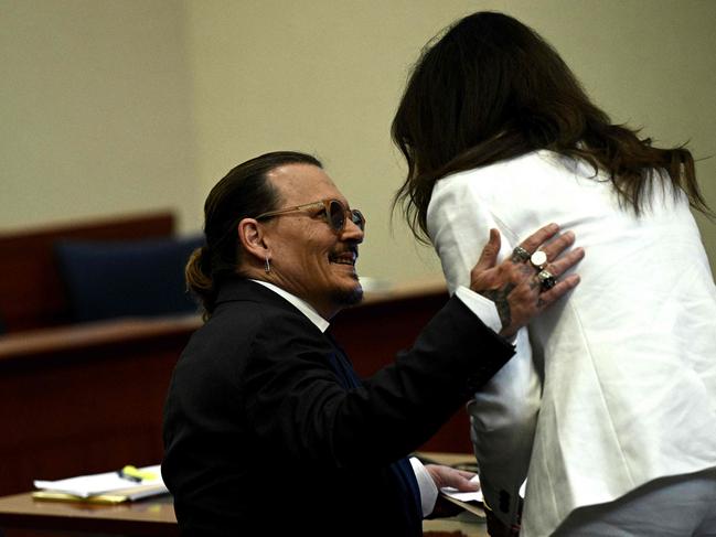 Johnny Depp speaks to his lawyer Camille Vasquez in the courtroom. Picture: AP