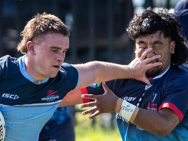 20th September 2022. News Local. SportDaceyville, Sydney, NSW, Australia.Pics by Julian Andrews.Rugby Union Action from the NSW Waratahs Under 18 team v Melbourne Rebels.Picture shows:WaratahÃs player(s): Louis Dalrymple hands off a Rebels playerRebels player(s):