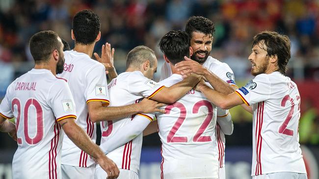 Spain's Diego Costa (2nd R) celebrates with teammates after scoring.