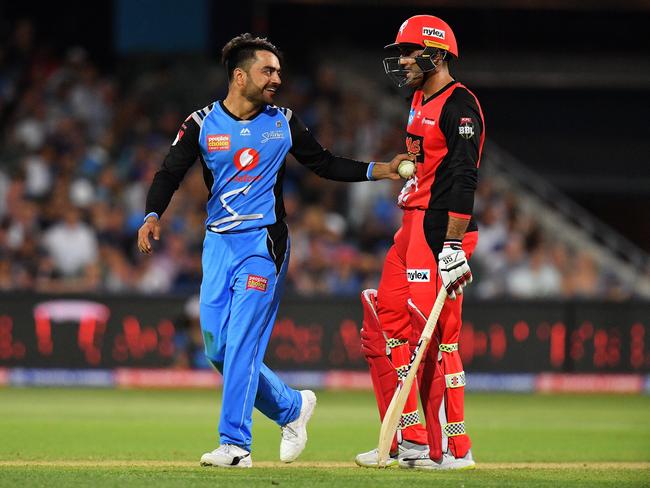 He knows: Rashid Khan laughs with Mohammad Nabi after the Renegade blasted him for six. Picture: Getty Images