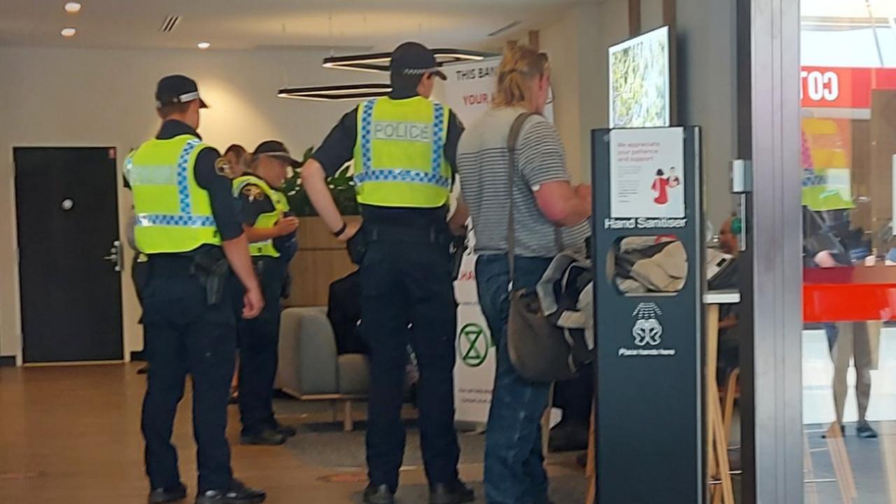 The arrest at NAB Launceston on December 7, 2022 of Extinction Rebellion protesters Graham Bailey, Pr Jeff McKinnon and Dr Scott Bell. Picture: XRNT