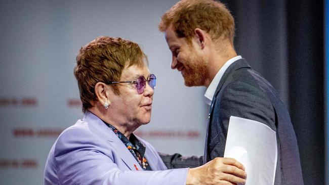 British Prince Harry (L) and sir Elton John attend a session about the Elton John Aids Fund on the second day of the Aids2018 conference, in Amsterdam on July 24, 2018. From 23 to July 27, thousands of delegates -- researchers, campaigners, activists and people living with the killer virus -- attend the 22nd International AIDS Conference amid warnings that "dangerous complacency" may cause an unstoppable resurgence. / AFP PHOTO / ANP / Robin Utrecht / Netherlands OUT