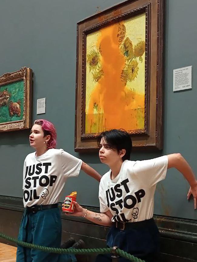 Activists bid to make their point in front of Vincent van Gogh’s Sunflowers at the National Gallery in London. Picture: AFP