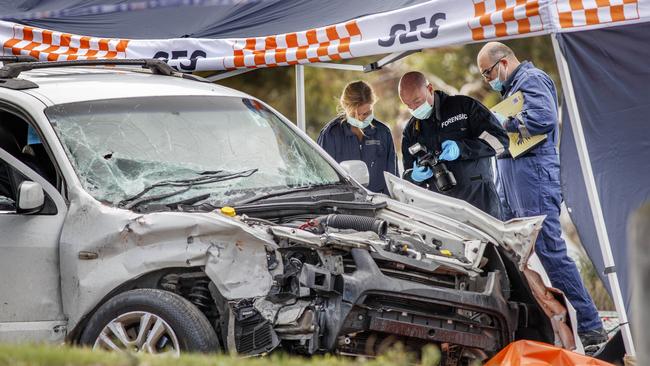 Forensic officers inspect the crashed car. Picture: NCA NewsWire/David Geraghty