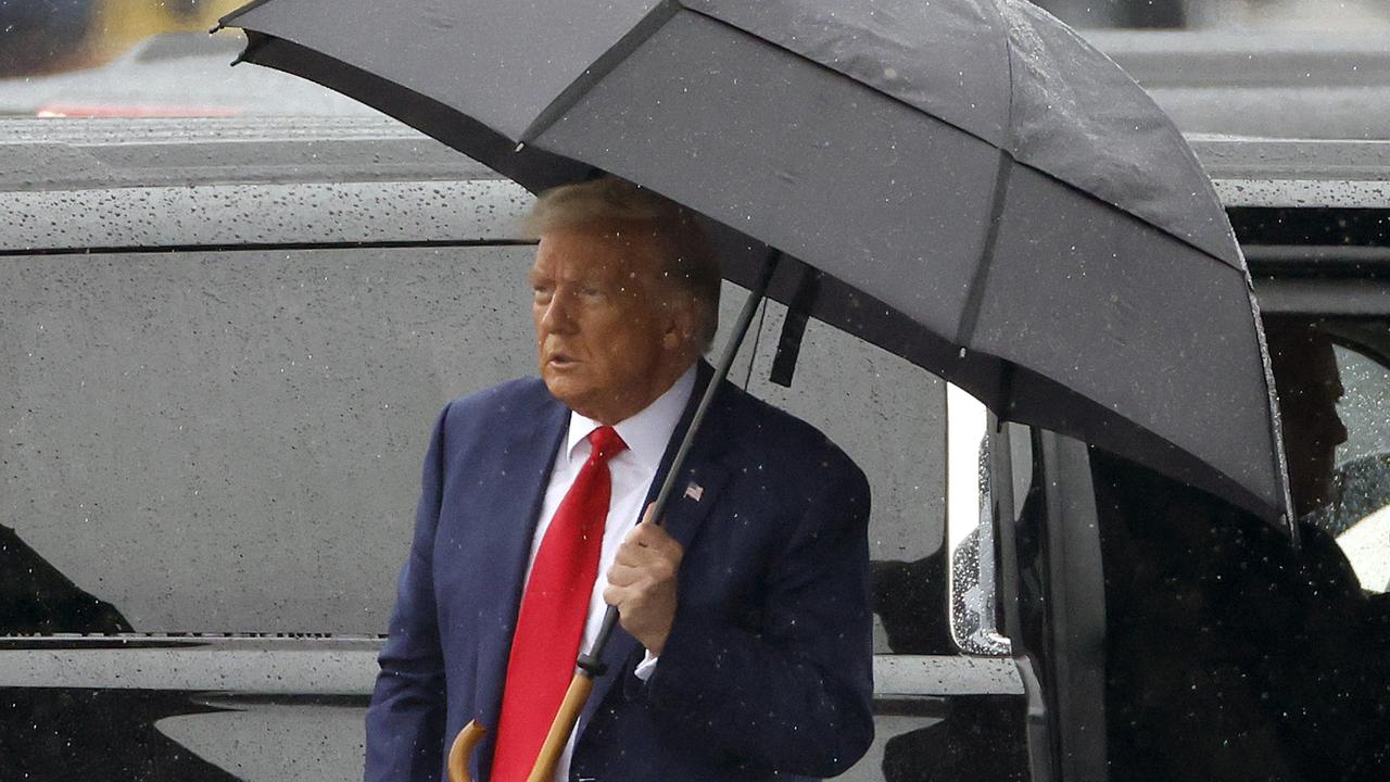 Former U.S. President Donald Trump holds an umbrella as he arrives at Reagan National Airport following an arraignment in a Washington, D.C. court on August 3, 2023 in Arlington, Virginia. Picture: Tasos Katopodis/Getty Images/AFP