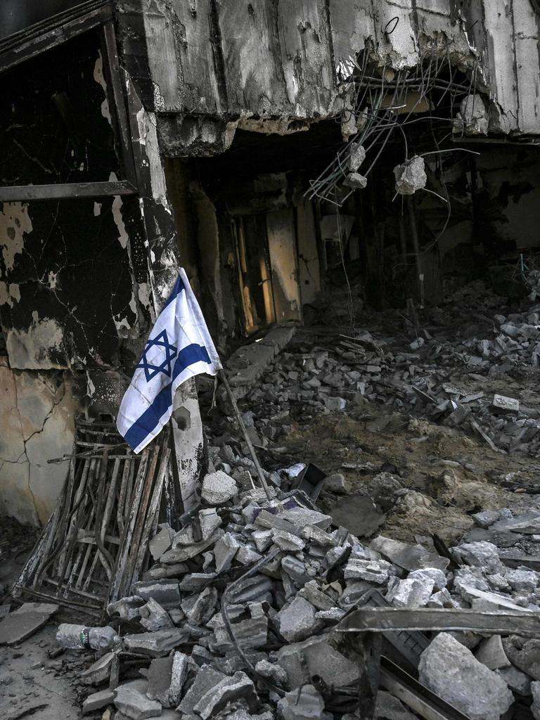 An Israeli flag placed at a destroyed house in Kibbutz Be'eri in southern Israel. Picture: AFP