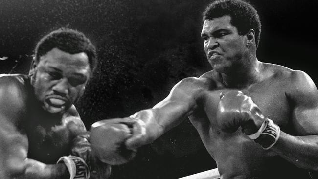 Perspiration flies from the head of challenger Joe Frazier as heavyweight champion boxer Muhammad Ali connects with a right in the ninth round of their bitter title fight in Manila in 1975. Picture: AP