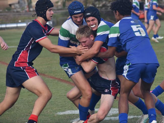 Emmaus College player Will McLaughlin is met by some stern defence from The Cathedral College in Round 1 of the Dolphins Cup at Rockhampton's Kettle Park on May 28, 2024.