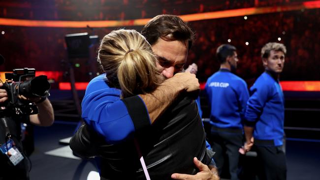 Federer hugs wife Mirka.