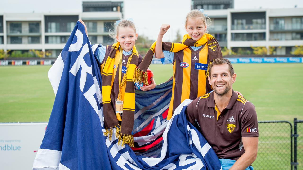 Hawthorn is relocating to Dingley, leaving Waverley Park open for new owners. Luke Hodge pictured with fans and the team’s premiership banner that they hung after winning the 2014 premiership.