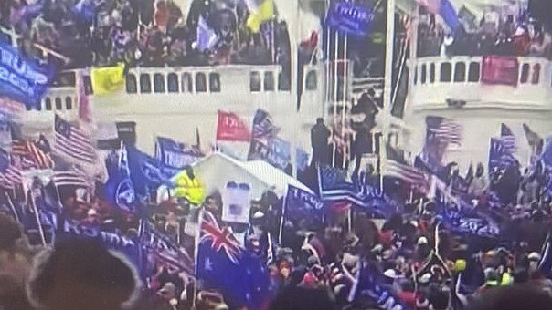 Among the sea of Confederate and US flags, a lone Australian flag is waved by a protester outside the Capitol building on January 6 last year. Source: Twitter