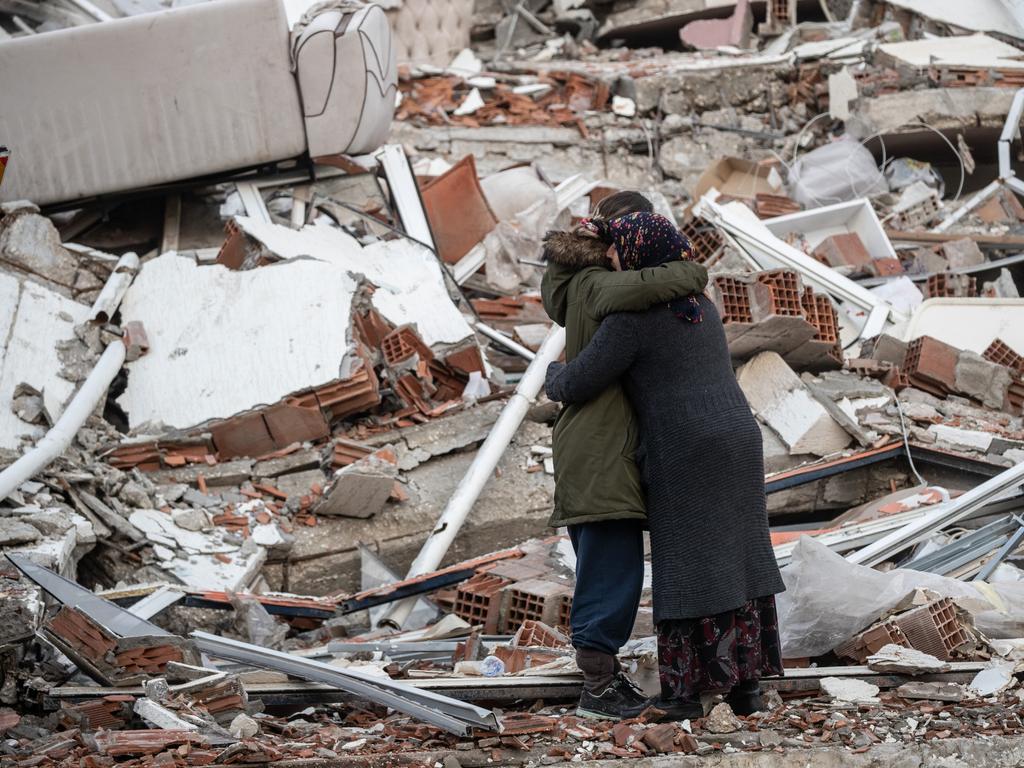 Women hug each other near a collapsed building in Hatay, Turkey. Picture: Getty Images