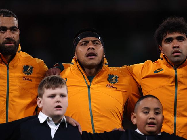 Australia's Lukhan Salakaia-Loto, Australia's Allan Alaalatoa and Australia's Langi Gleeson sing the national anthem during the second Test rugby union match between Australia and Wales at AAMI Park in Melbourne on July 13, 2024. (Photo by Martin KEEP / AFP) / -- IMAGE RESTRICTED TO EDITORIAL USE - STRICTLY NO COMMERCIAL USE --