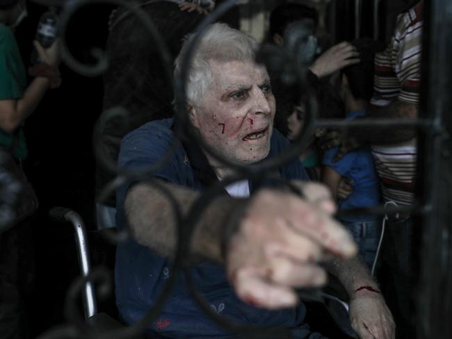 An elderly Palestinian man is injured after Israeli air strikes destroy buildings in Gaza City. Picture: Belal Khaled/Anadolu Agency via Getty Images