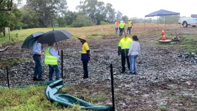 Council officers work to trace the leaking pipe. Picture: AECOM report