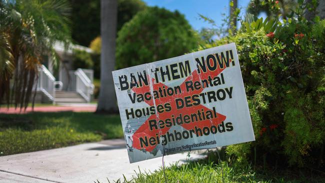 A sign reading '' Ban Them Now! Vacation Rental Houses Destroy Residential Neighborhoods'' is displayed in front of a home on June 28, 2024 in Hollywood, Florida. Florida Gov. Ron DeSantis vetoed a bill that would have given the state more control over the regulation of short-term vacation rentals like Airbnb and Vrbo. Joe Raedle/Getty Images/AFP (Photo by JOE RAEDLE / GETTY IMAGES NORTH AMERICA / Getty Images via AFP)