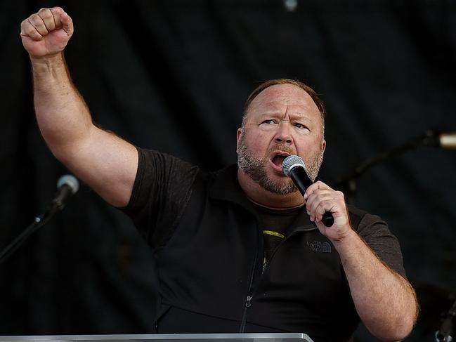 (FILES) In this file photo taken on December 12, 2020, US far-right radio show Alex Jones speaks to supporters of US President Donald Trump as they demonstrate in Washington, DC, to protest the 2020 election. - Jones, who has been ordered to pay nearly $1.5 billion to the families of victims of the Sandy Hook school shooting, declared personal bankruptcy on December 2, 2022. Jones, who falsely claimed for years that the 2012 massacre was a hoax, filed for Chapter 11 bankruptcy protection with a court in his home state of Texas. In the filing, Jones said he has assets worth between $1 million and $10 million and liabilities of between $1 billion and $10 billion. (Photo by Olivier DOULIERY / AFP)