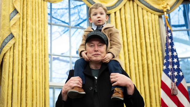 Elon Musk carries his son X Æ A-Xii, who he shares with experimental musician Grimes, on his shoulders in the Oval Office of the White House in February. Picture: Jim Watson/AFP