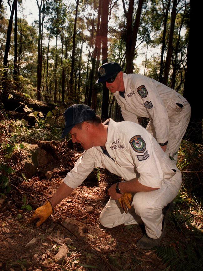 Constable Peter Edwards (L) and Sergeant Ron Gibson from Newcastle Police Rescue search Watagan State Forest after three bodies believed to be Susan Park and her two children Amy and Andrew were discovered in suitcases.