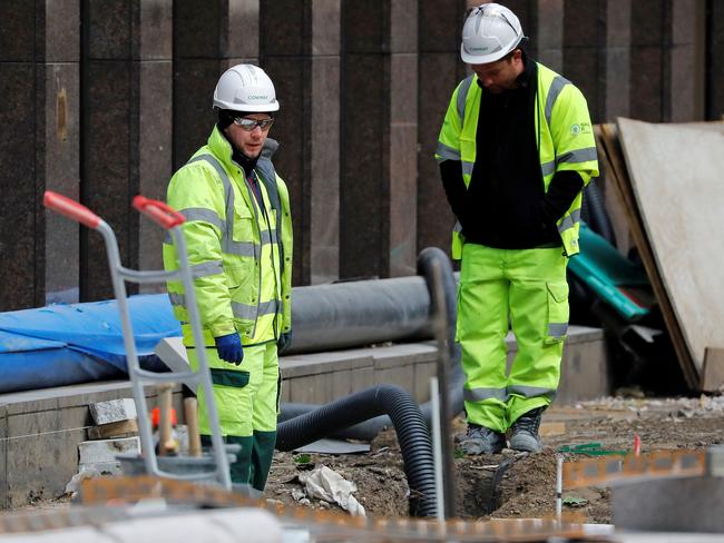 Workers in a hard hats work on a building construction site in central London on May 11, 2020, as life in Britain continues during the nationwide lockdown due to the novel coronavirus pandemic. - British Prime Minister Boris Johnson on May 10 announced a phased plan to ease a nationwide coronavirus lockdown, with schools and shops to begin opening from June 1 -- as long as infection rates stay low. Starting this week, he said the government would be "actively encouraging" people to return to work where they could not do so from home, for example in manufacturing or construction. (Photo by Tolga AKMEN / AFP)