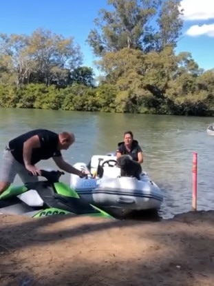 Mr Twitchin can be seen having apparently climbed onto one of the jetskis. Photo: Facebook