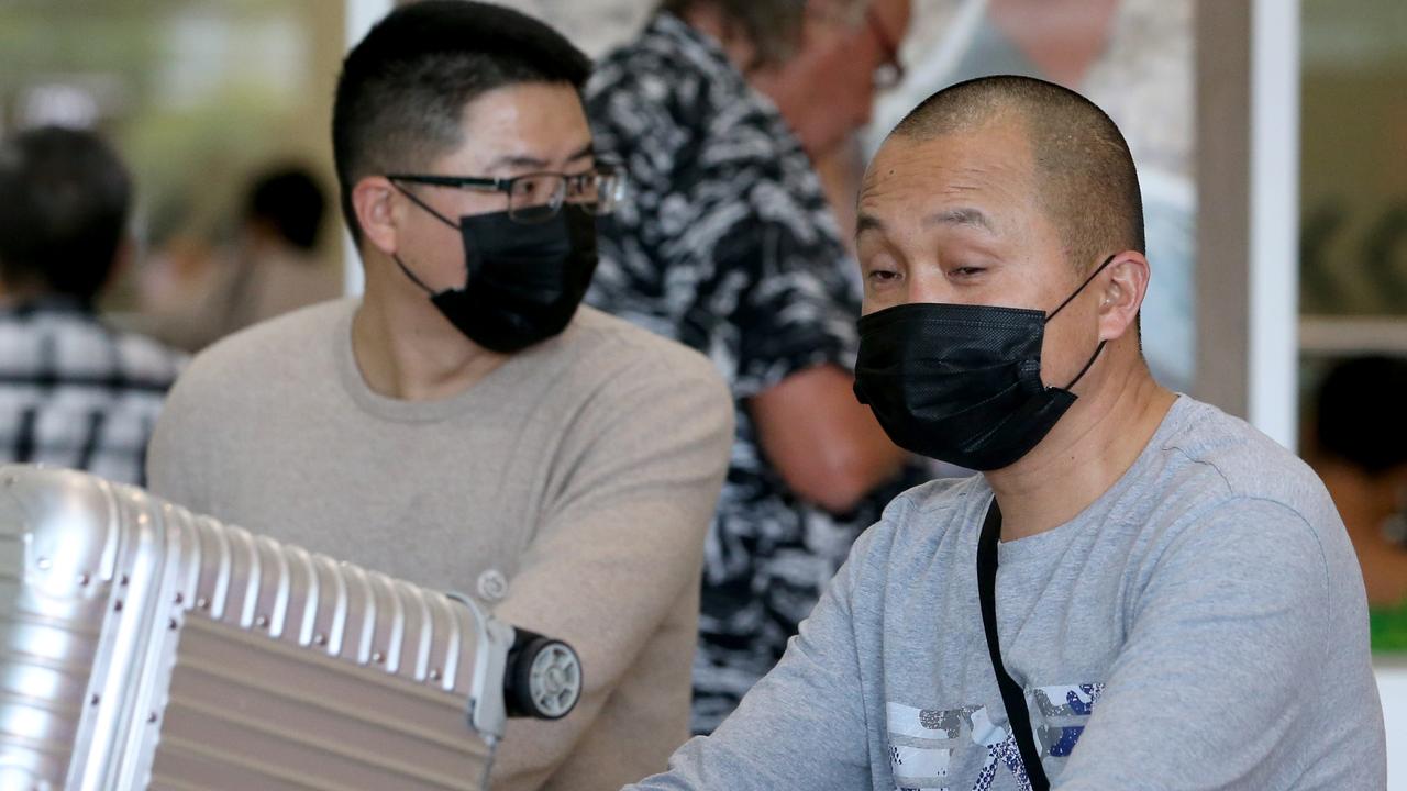 Passengers in masks at Brisbane International Airport. Picture: Steve Pohlner