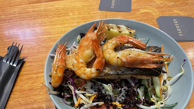 The pan fried salmon served with black rice, garden salad, cherry tomato and prawns. Picture: Patrick Morrow