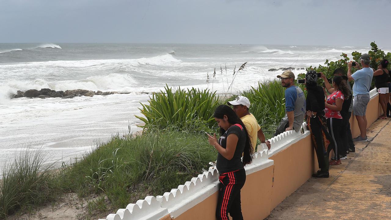 Floridians watch as waves lash the shore. Picture: Getty Images/AFP