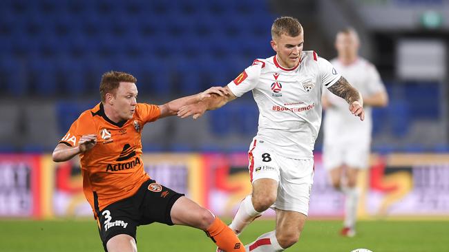 Roar defender Corey Brown (left) tackles Adelaide United star Riley McGree. Picture: Albert Perez/Getty Images