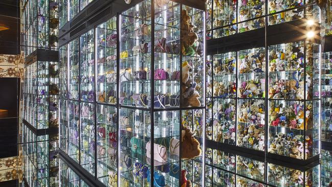 Glass cabinets are stacked with hundreds of ceramic plates, 160 Gucci marmont handbags and 1800 teddy bears.