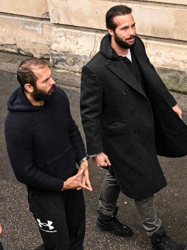 Tate held the gesture throughout his walk into court in front of the media. Picture: Daniel Mihailescu/AFP