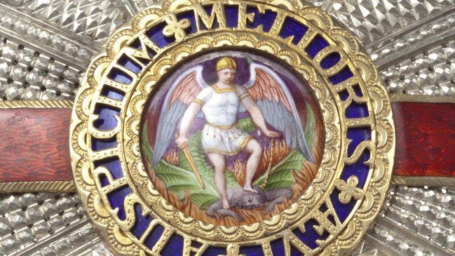 The Knighthood medal depicts a white St Michael on the throat of a black Satan. Picture: Alamy.