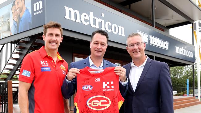 2019: Gold Coast Suns co-captain David Swallow, Metricon director Queensland Jason Biasin and Suns CEO Mark Evans. Picture: Tim Marsden