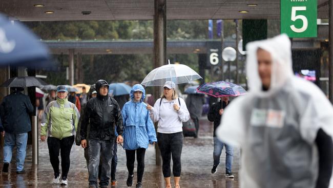 People out in the rain at Circular Quay. Lots of rain forecast for Saturday and Sunday In Sydney. Picture: NewsWire / Damian Shaw