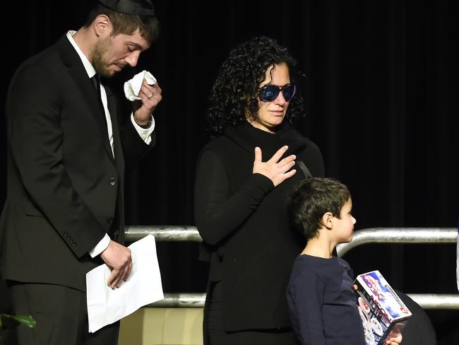Jonathon Sherman and his sister Lauren weep during a December 21 memorial service in Mississauga, Ontario, for their parents Barry and Honey Sherman. Picture: Nathan Denette/The Canadian Press via AP