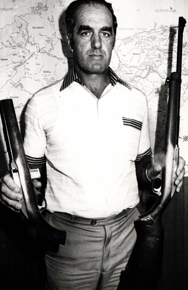 Retired assistant police commissioner Eric Strong, pictured in the 1980s, holds a .22 rifle and a sawn-off shot gun — similar to what the balaclava killer used.