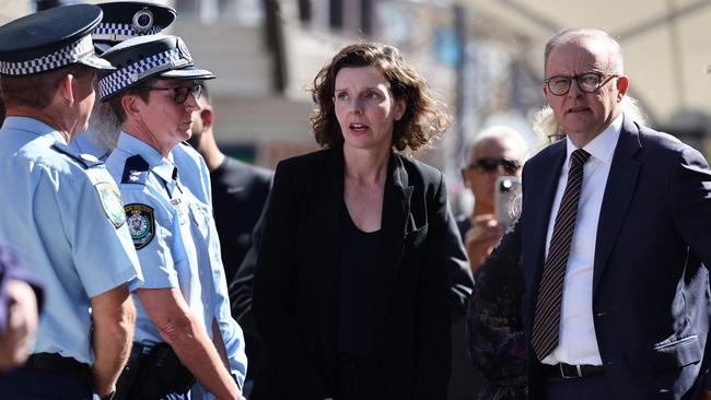 Prime Minister Anthony Albanese stands with federal MP Allegra Spender as they talk to police at the Westfield Bondi Junction shopping mall on Sunday. Picture: David Gray/AFP